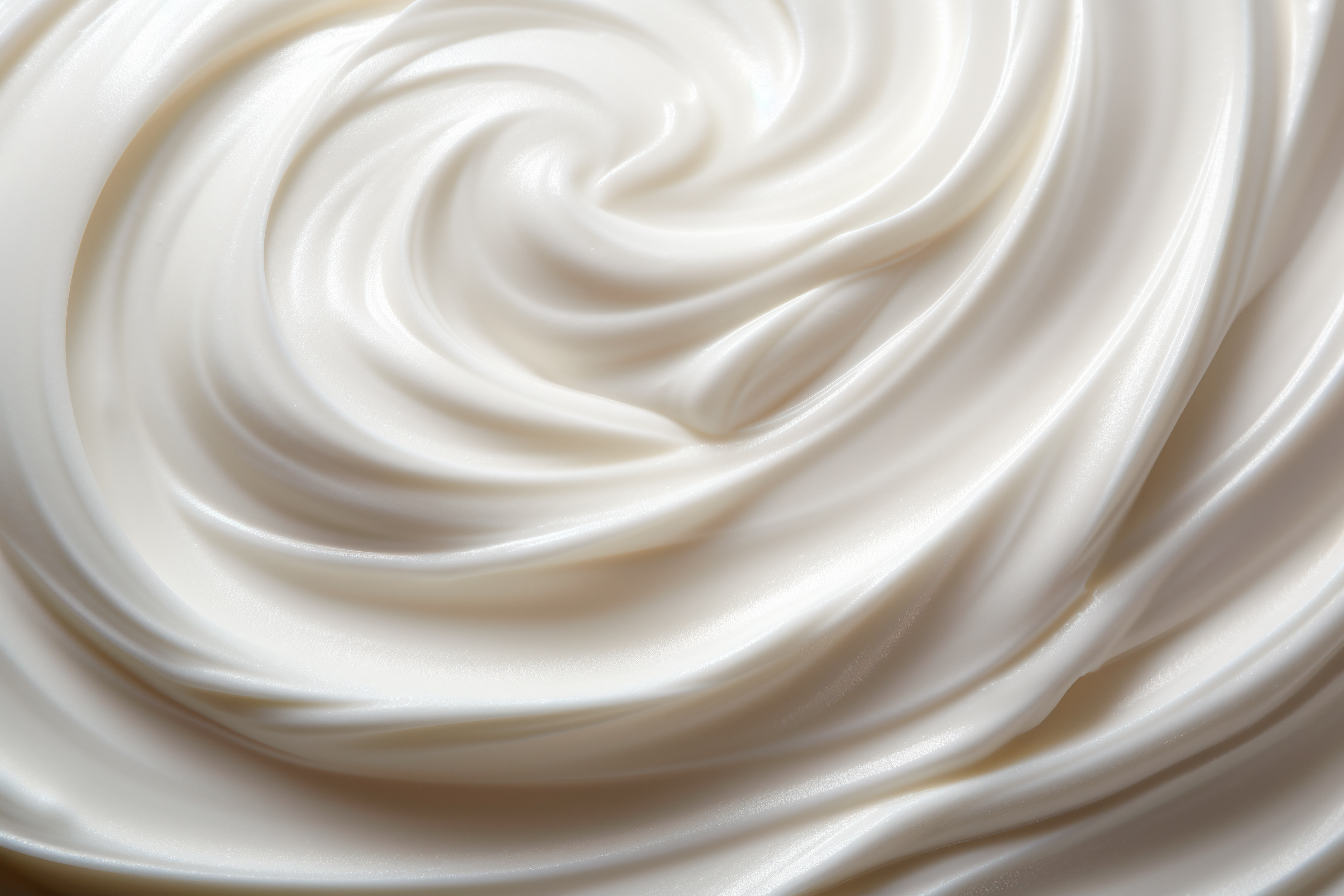 Close-up of a smooth, creamy, white, anti-aging, nourishing moisturizer with a rich, hydrating texture.